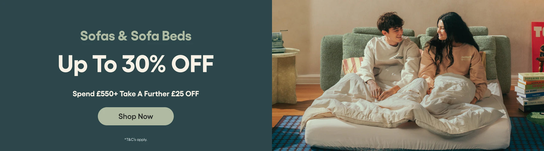 Promotional banner for sofas and sofa beds with a couple on a bed, text overlay, and call to action button.