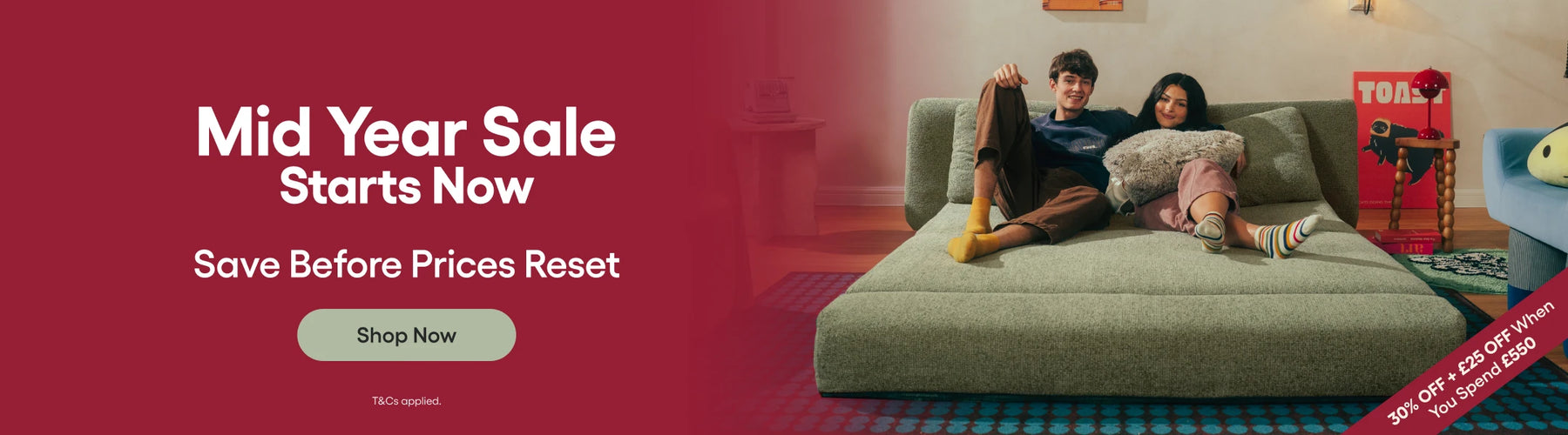 Promotional banner for a mid-year sale with a couple on a couch.