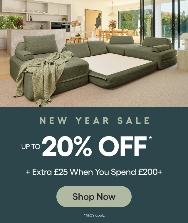 Green sectional sofa in a living room with a New Year Sale advertisement overlay.